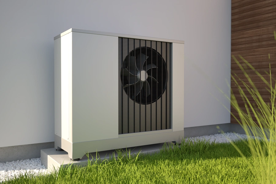 Outdoor air source heat pump unit installed beside a house