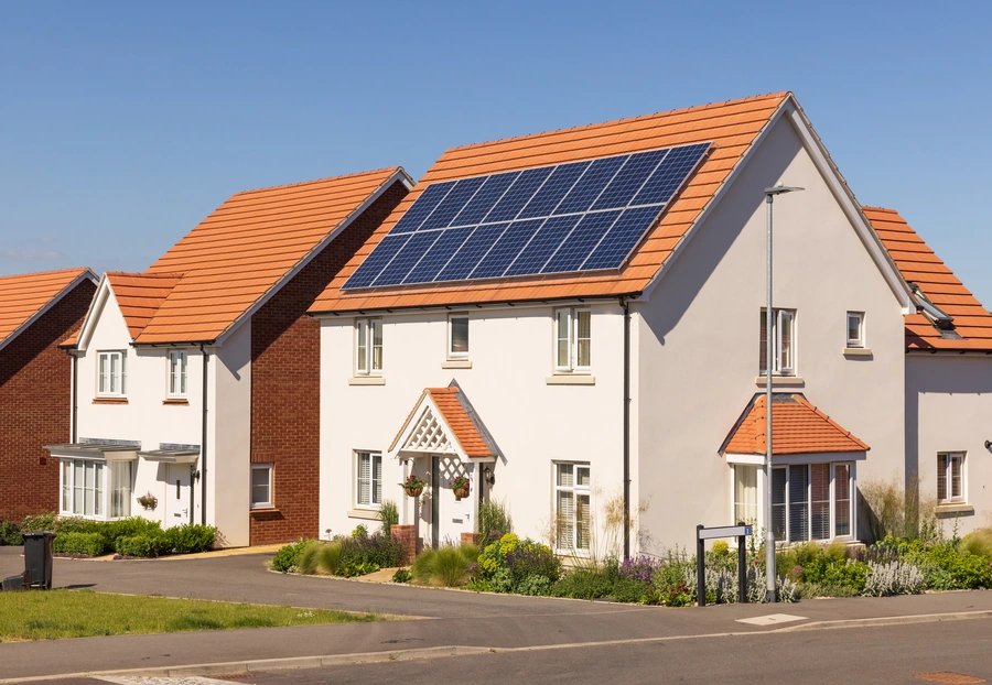 Modern detached house with solar panels installed on the roof