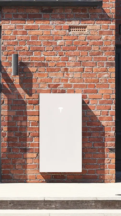 Tesla Powerwall on the outside wall of a detached house